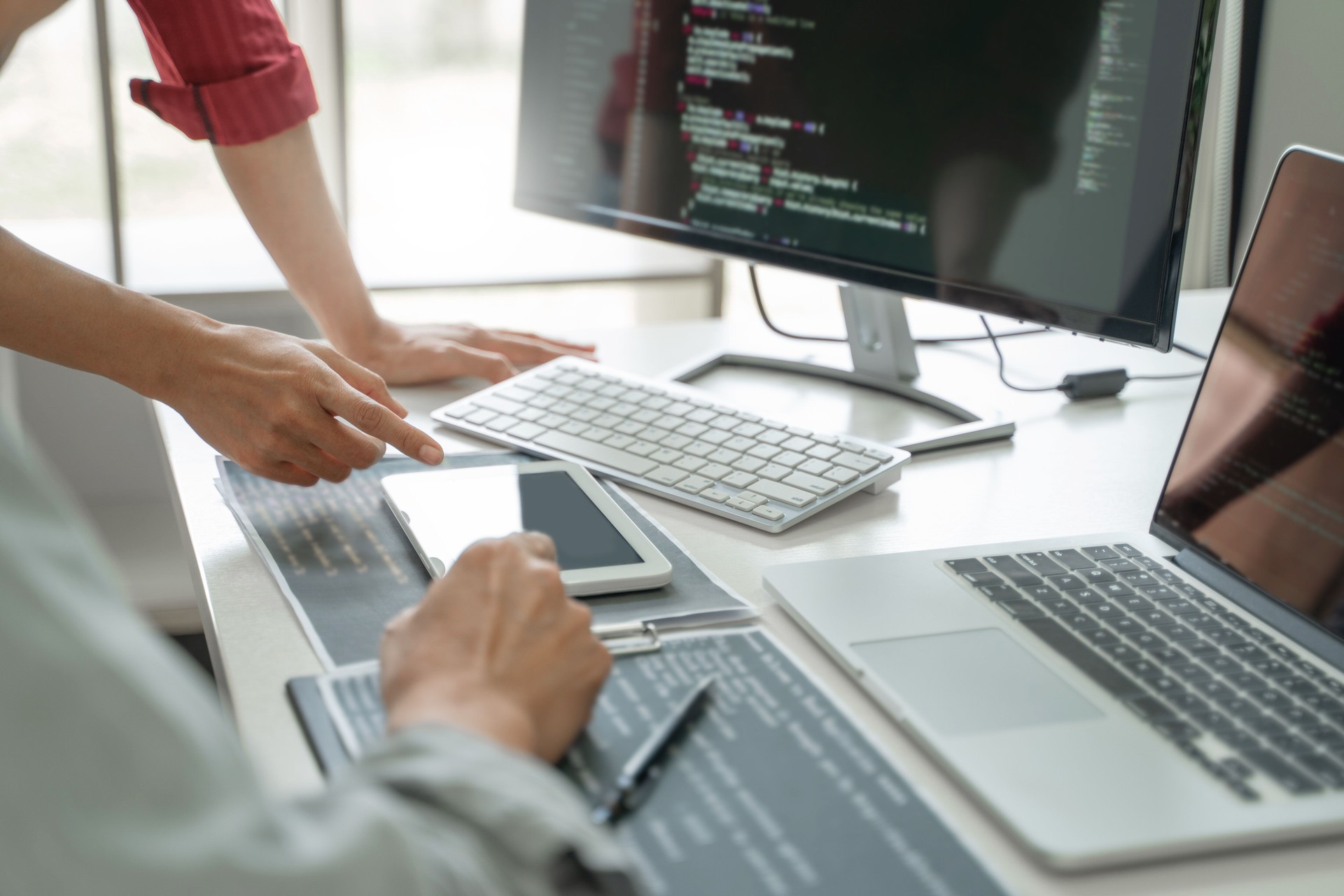 Development programmer writing a code on database, Teamwork cooperation.